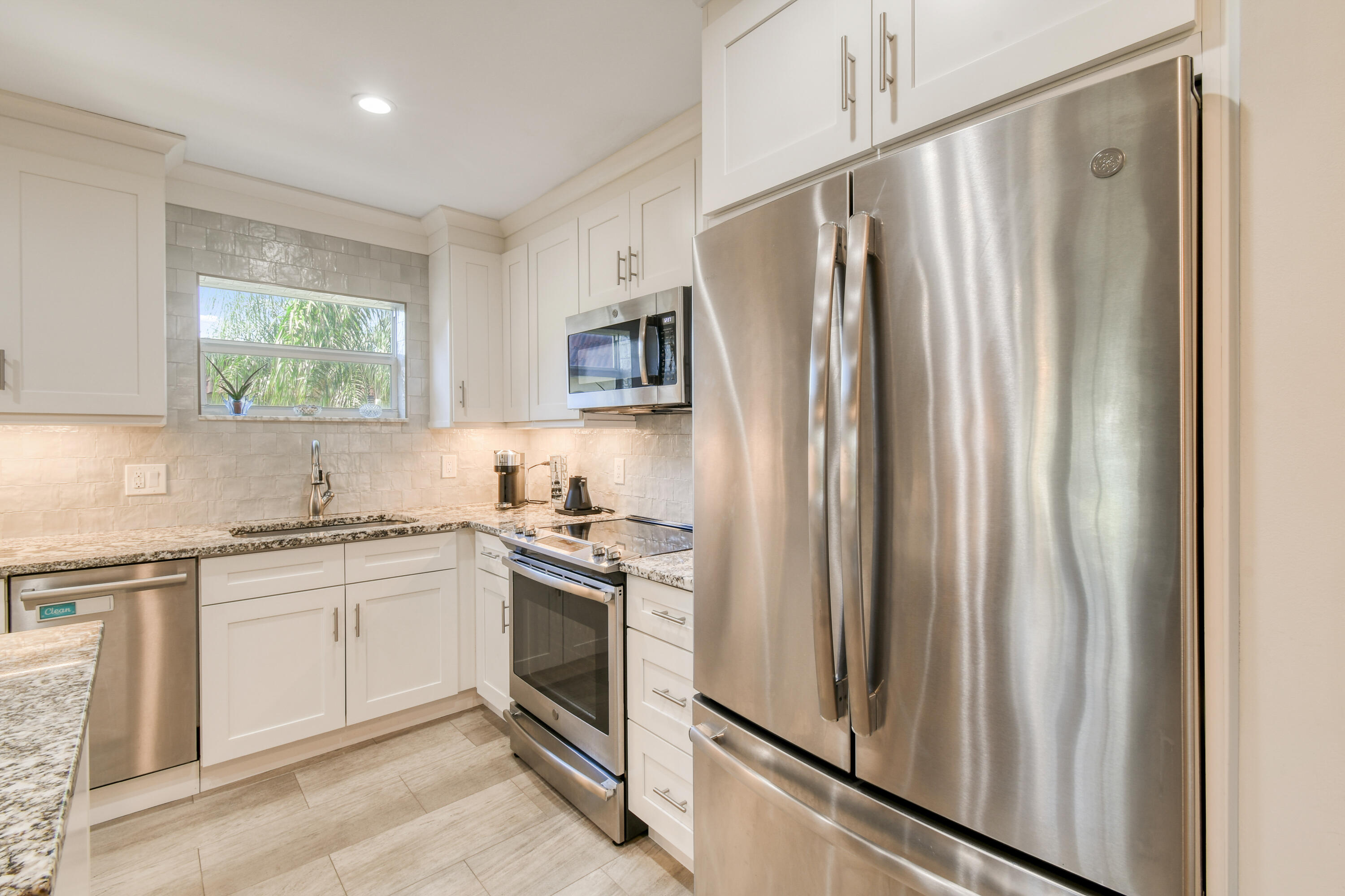 717 Highway 1, Unit 508 Jupiter, FL 33477 - Photo 11 of 66 a kitchen with stainless steel appliances granite countertop a refrigerator sink and stove