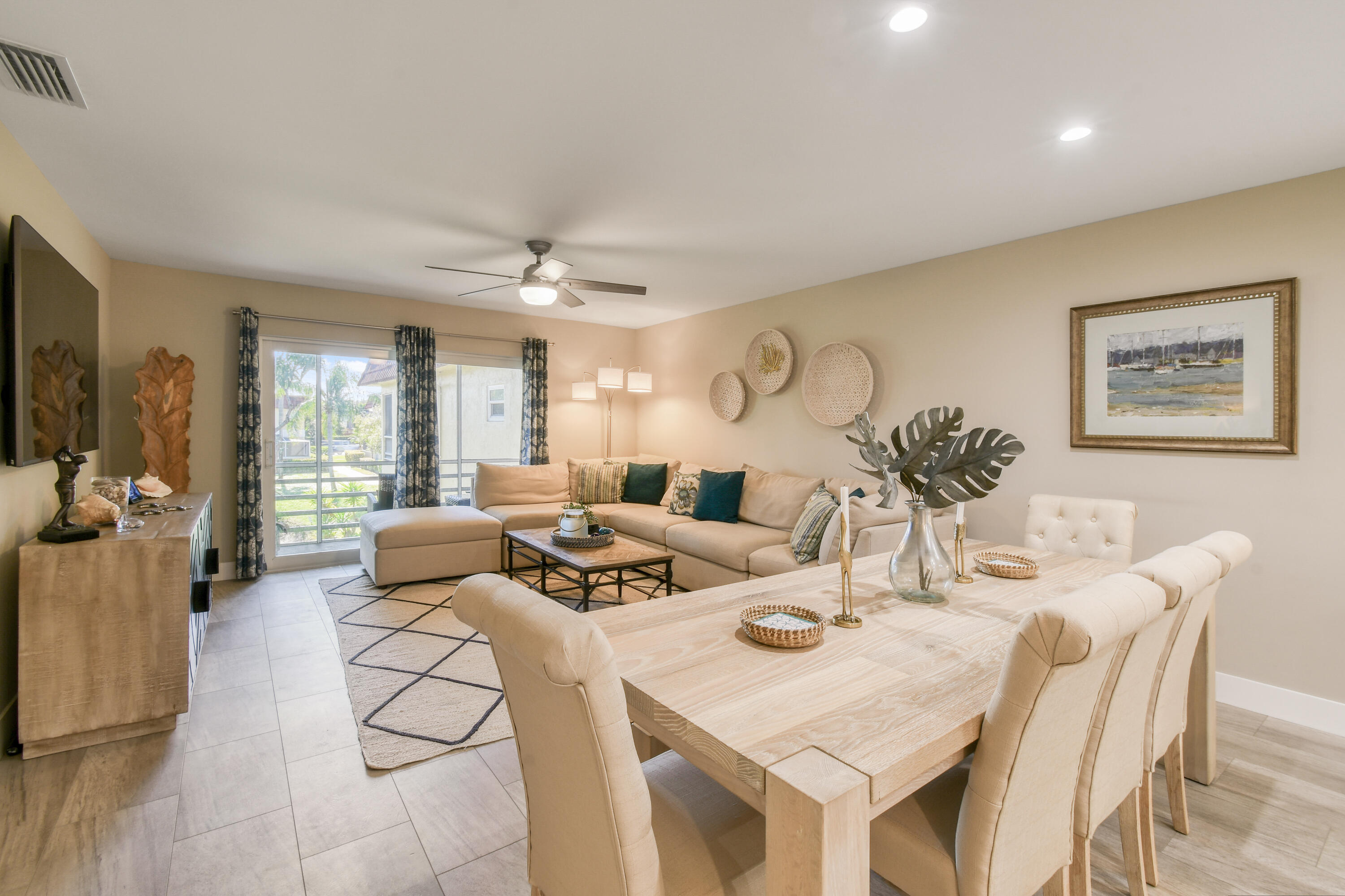 717 Highway 1, Unit 508 Jupiter, FL 33477 - Photo 14 of 66 a living room with furniture a large window and dining table