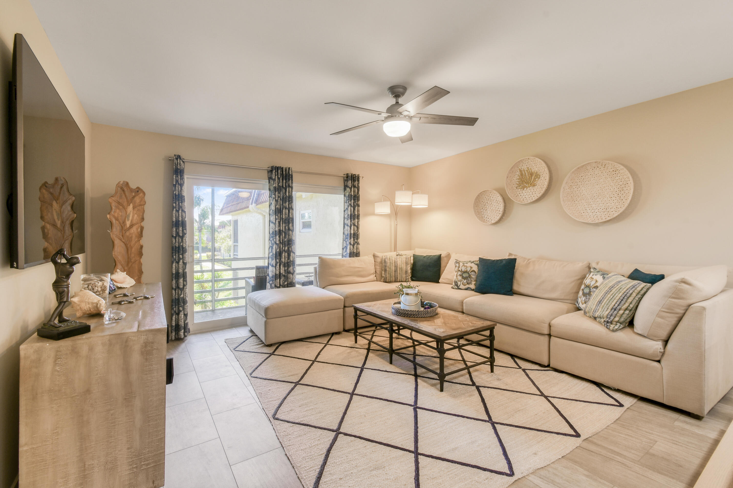 717 Highway 1, Unit 508 Jupiter, FL 33477 - Photo 15 of 66 a living room with furniture a chandelier fan and a large window