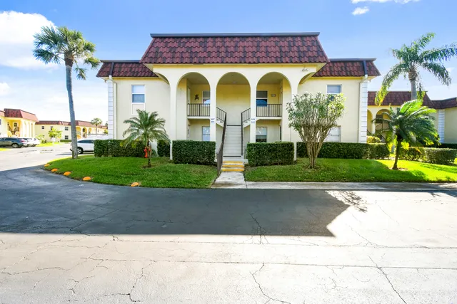 a view of a brick house with a yard