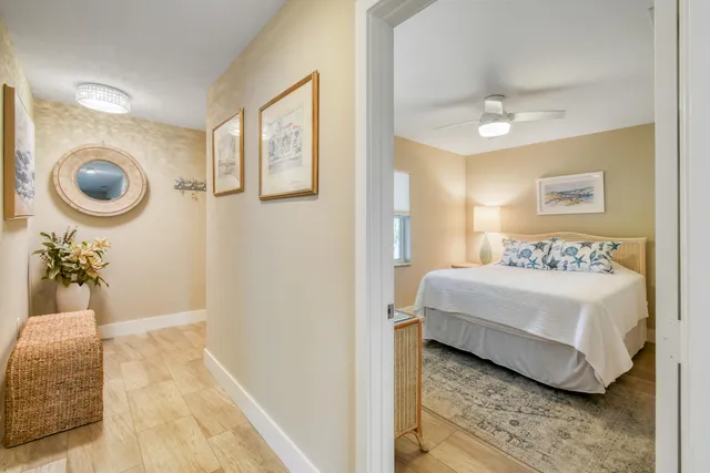 a bedroom with two beds and a potted plant
