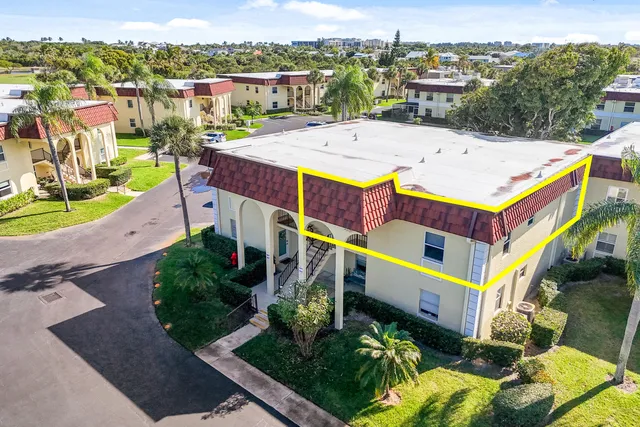 an aerial view of residential houses with outdoor space