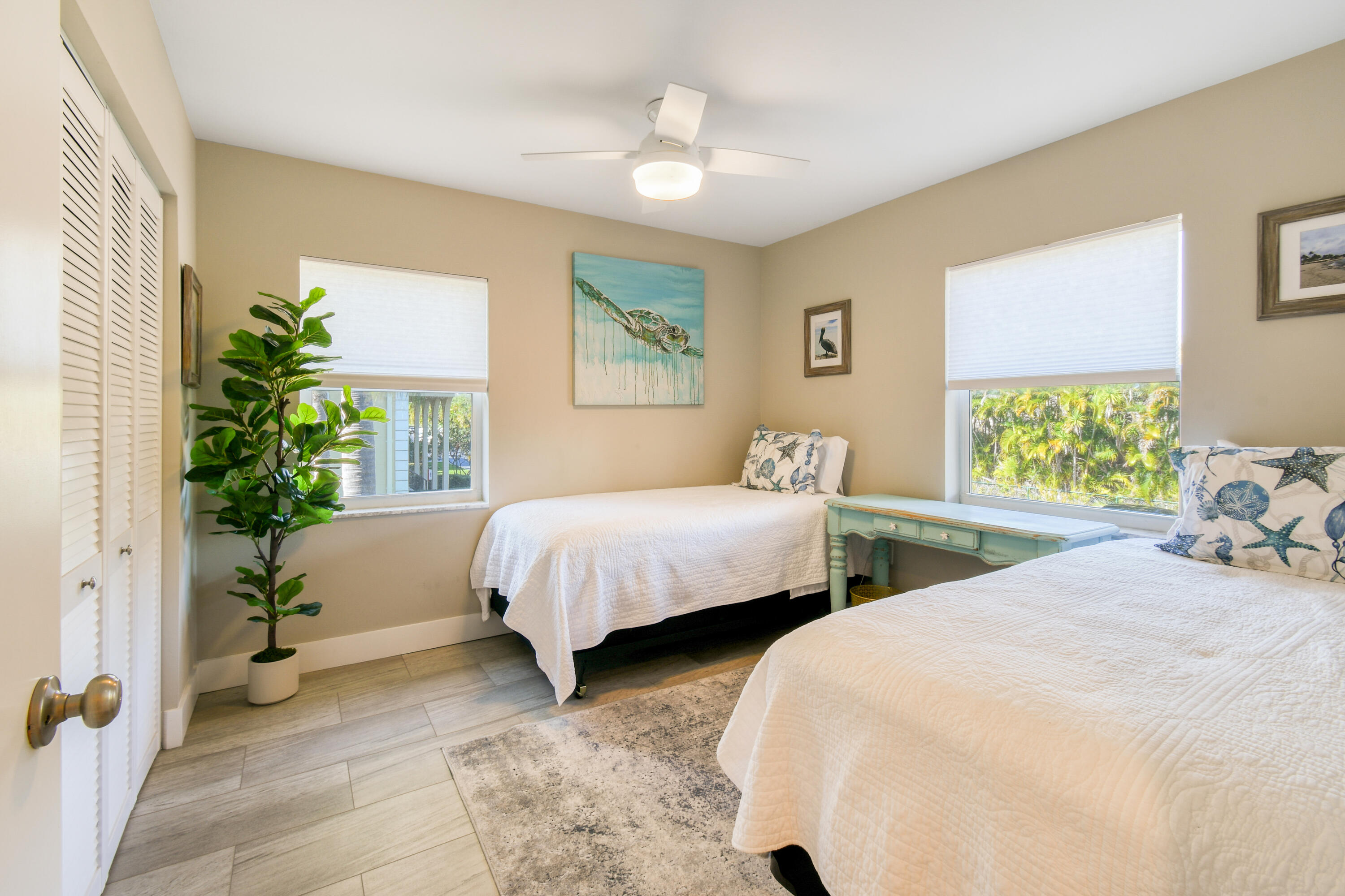 717 Highway 1, Unit 508 Jupiter, FL 33477 - Photo 34 of 66 a bedroom with two beds and a potted plant