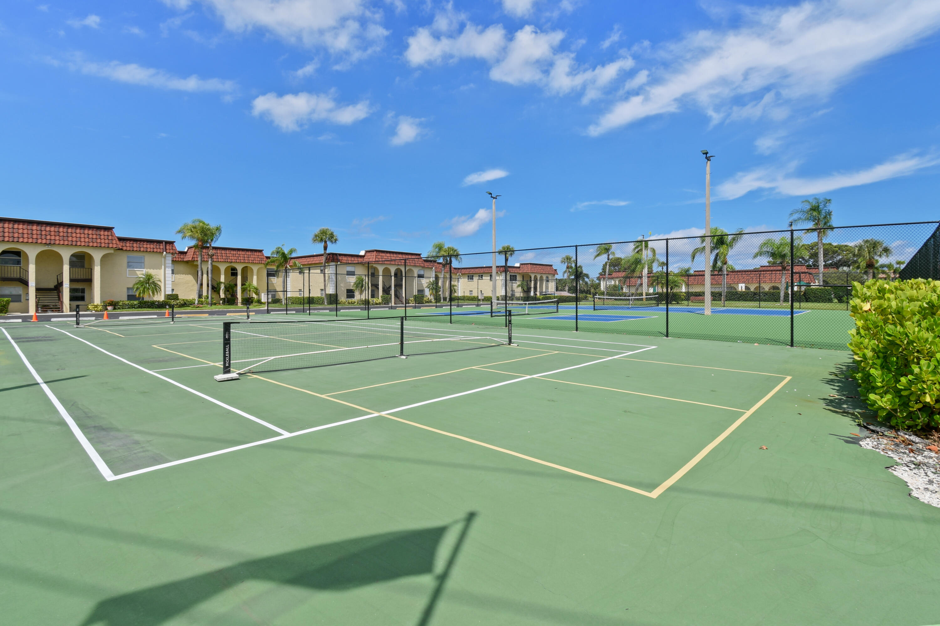 717 Highway 1, Unit 508 Jupiter, FL 33477 - Photo 45 of 66 a view of a tennis ground with large trees