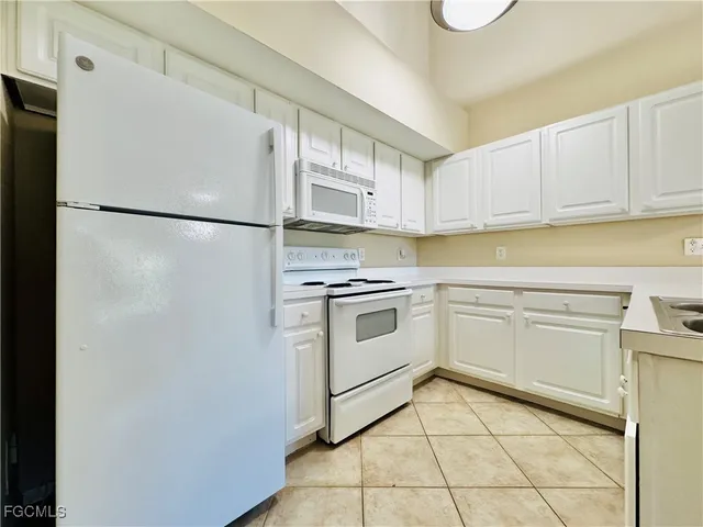 a kitchen with cabinets stainless steel appliances and counter space