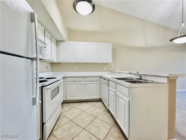 a kitchen with a stove top oven sink and cabinets