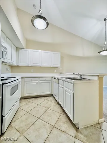 a kitchen with a cabinets and white appliances
