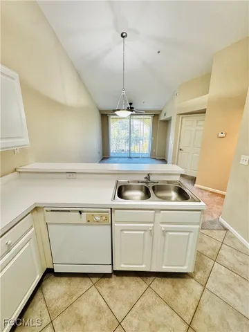a kitchen with a stove a sink a refrigerator and window