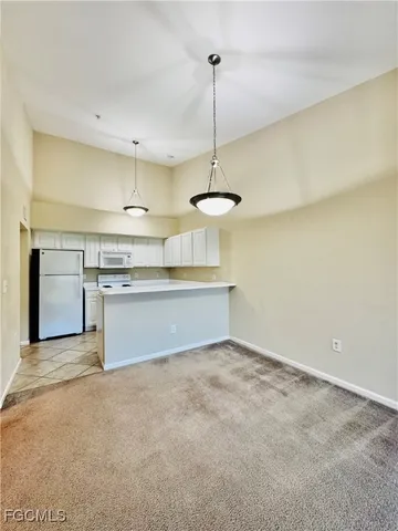 a view of a kitchen with a sink dishwasher a stove top oven and cabinets