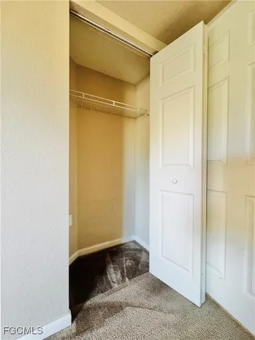 a bedroom with a bed and a cabinet