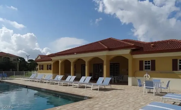 a view of house with swimming pool and furniture