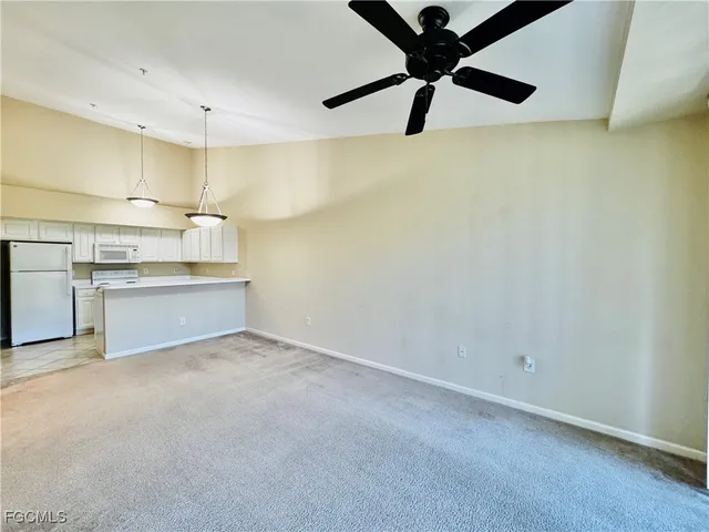 a view of a kitchen with a sink and a refrigerator