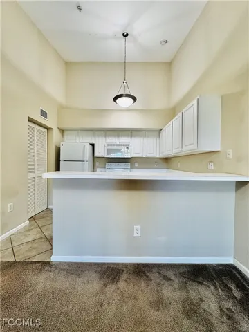 a kitchen with kitchen island stainless steel appliances a sink a stove a refrigerator a center island and cabinets