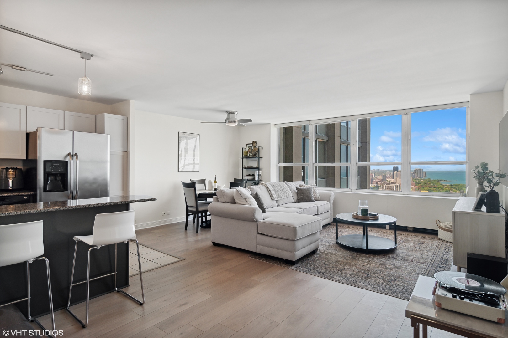 655 West Irving Park Road, Unit 5208 Chicago, IL 60613 - Photo 5 of 16 a living room with furniture and a flat screen tv