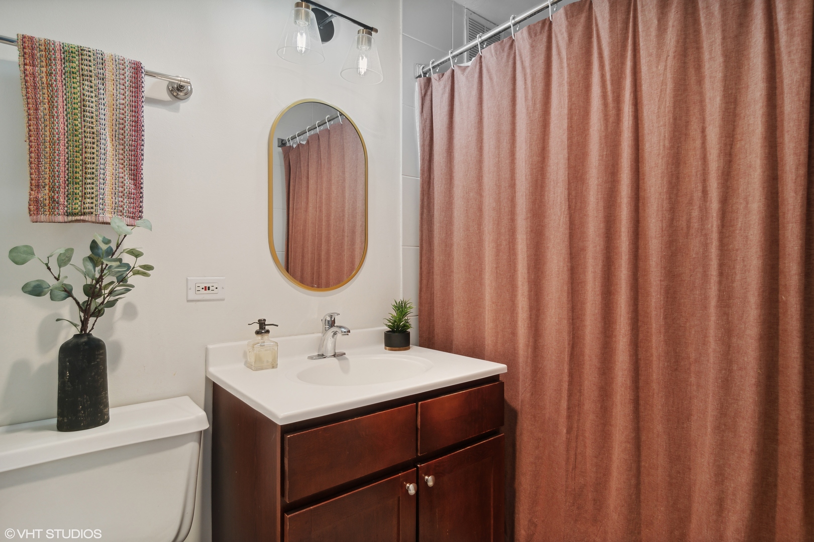 655 West Irving Park Road, Unit 5208 Chicago, IL 60613 - Photo 8 of 16 a bathroom with a sink and a mirror