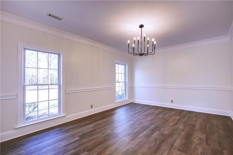 142 Carr Road LaGrange, GA 30241 - Photo 11 of 109 an empty room with wooden floor chandelier and windows