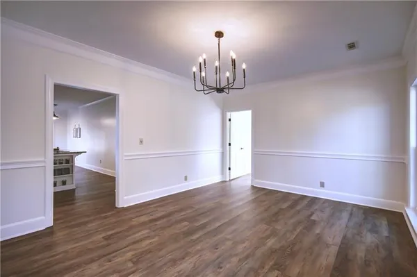 a view of an empty room with a fireplace and a window