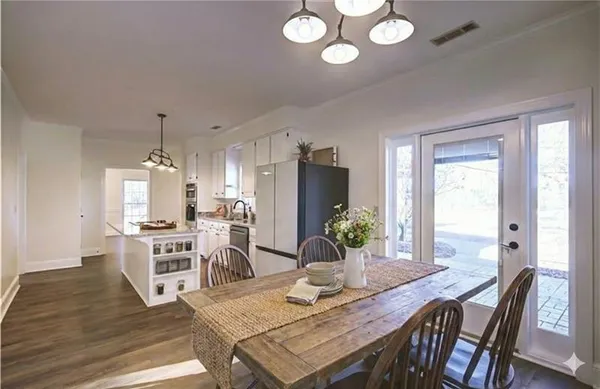 a bathroom with a bathtub sink and mirror