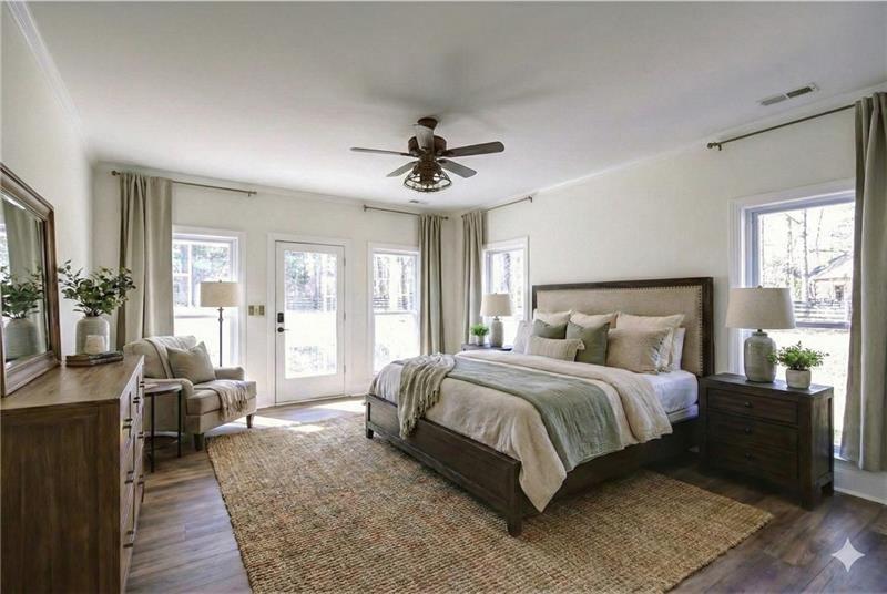 142 Carr Road LaGrange, GA 30241 - Photo 30 of 109 a bedroom with a large bed a chandelier and windows