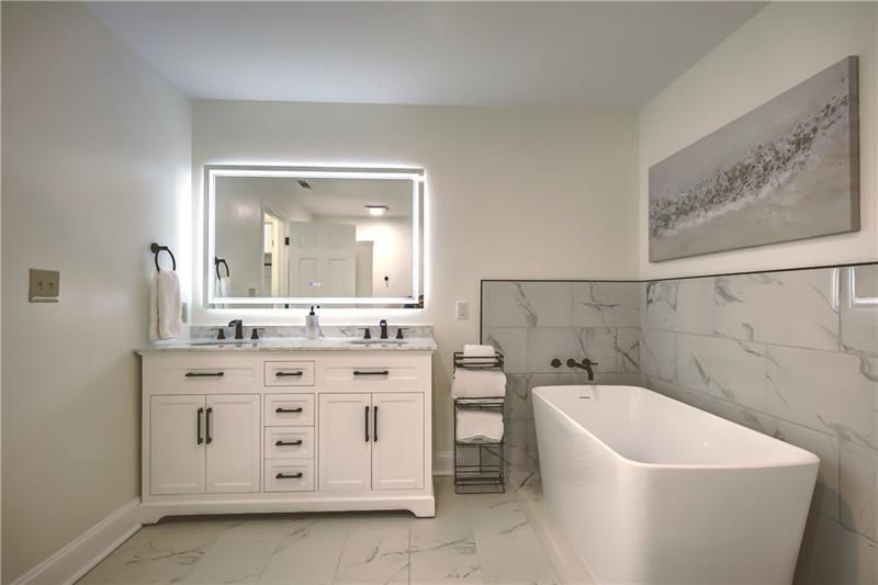 142 Carr Road LaGrange, GA 30241 - Photo 36 of 109 a bathroom with a bathtub sink and mirror