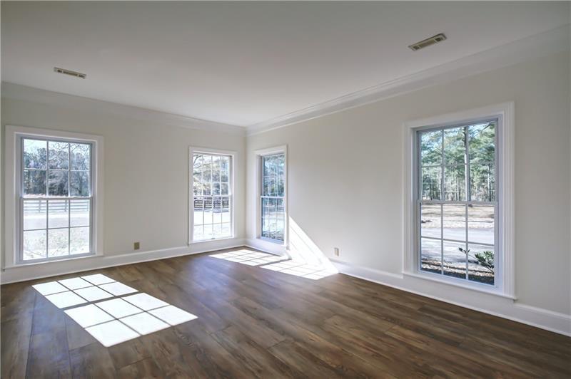142 Carr Road LaGrange, GA 30241 - Photo 9 of 109 a view of an empty room with wooden floor and a window