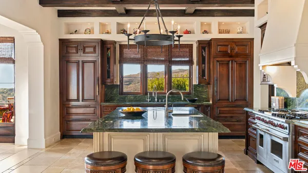 a kitchen with a stove and a refrigerator
