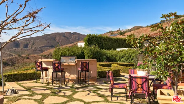 a view of a chairs and table in patio