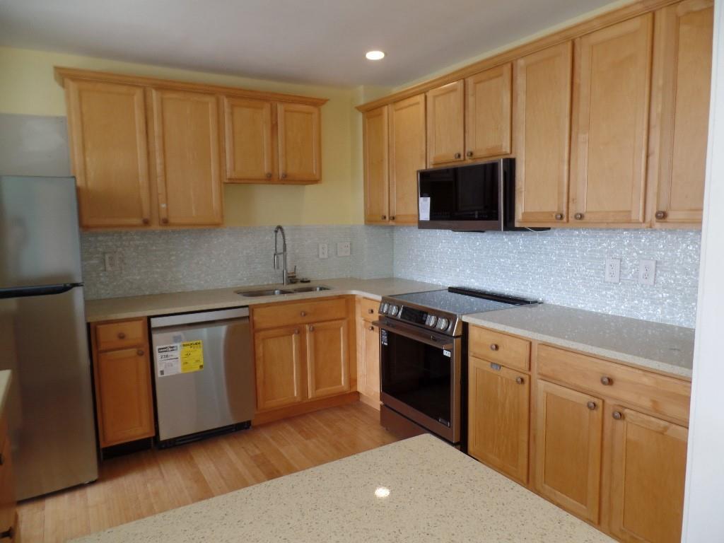 320 Fort Duquesne Boulevard, Unit 24M Pittsburgh, PA 15222 - Photo 11 of 40 a kitchen with stainless steel appliances granite countertop a stove a sink and a microwave