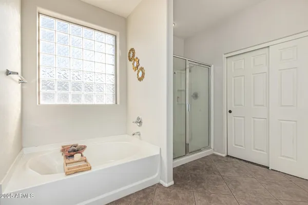 a bedroom with two beds and a window