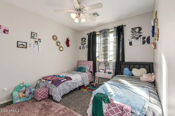 a view of a livingroom with a ceiling fan and window