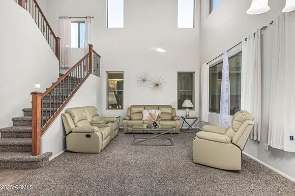 a living room with furniture and stairs