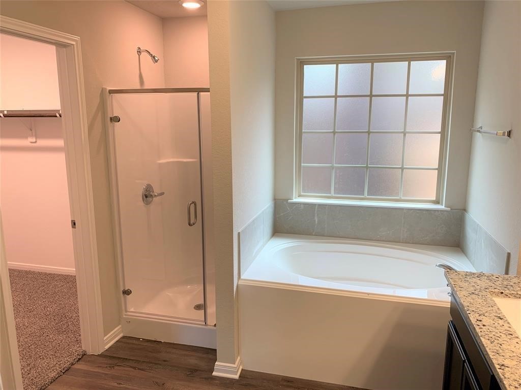 994 Arbor Crossing Conroe, TX 77303 - Photo 5 of 9 a bathroom with a bathtub and a shower
