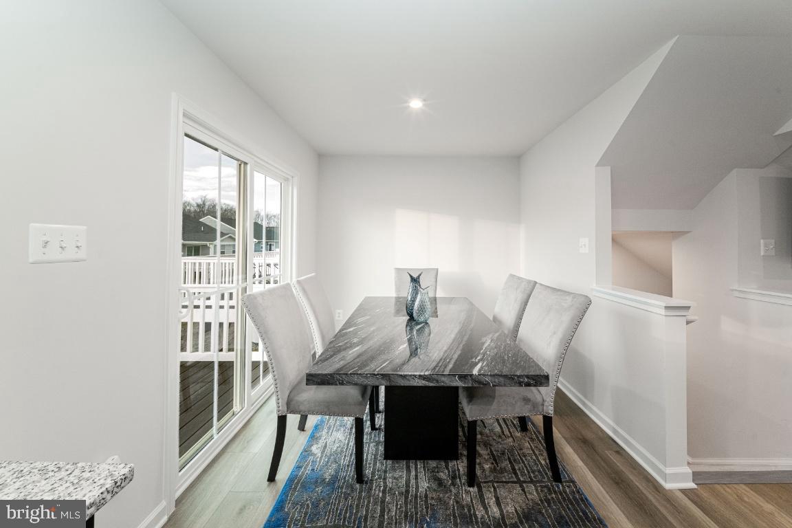 18256 Capital Court Ruther Glen, VA 22546 - Photo 14 of 26 a view of a dining room with furniture window and wooden floor