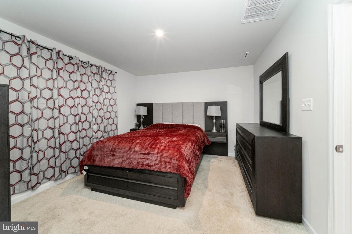 18256 Capital Court Ruther Glen, VA 22546 - Photo 16 of 26 a bedroom with a bed and a chair