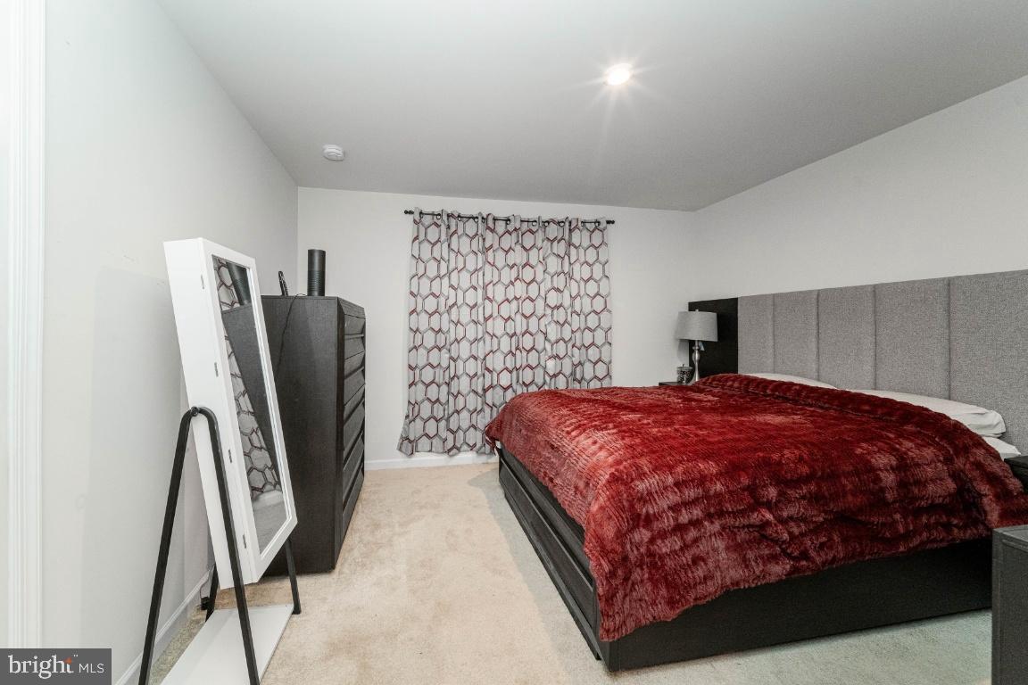 18256 Capital Court Ruther Glen, VA 22546 - Photo 17 of 26 a bedroom with a bed and a mirror