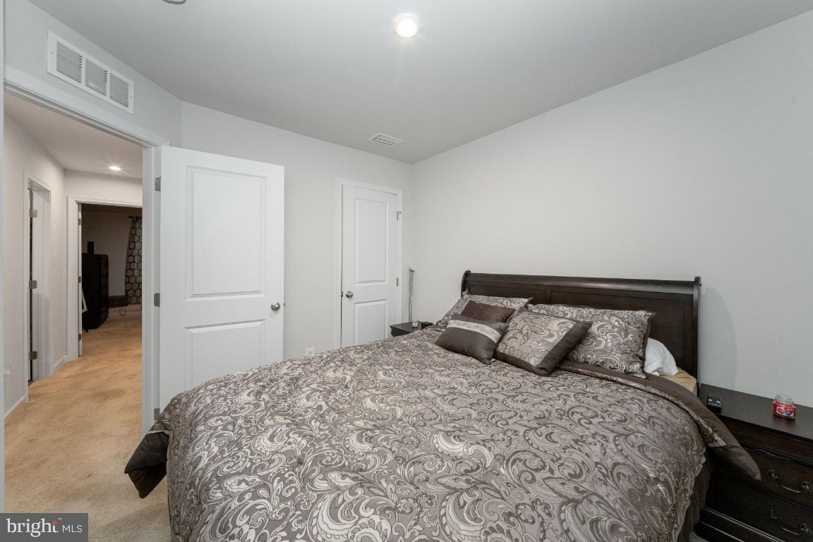 18256 Capital Court Ruther Glen, VA 22546 - Photo 18 of 26 a bedroom with a bed and a lamp