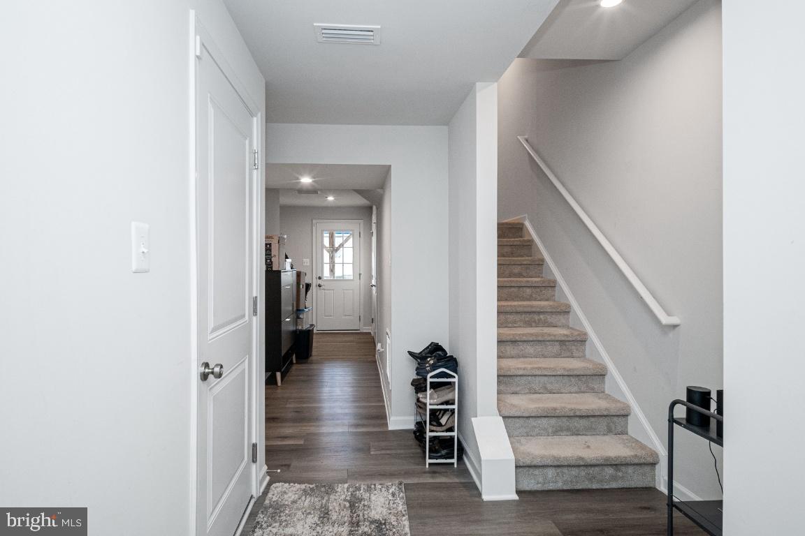 18256 Capital Court Ruther Glen, VA 22546 - Photo 4 of 26 a view of a hallway with wooden floor and staircase