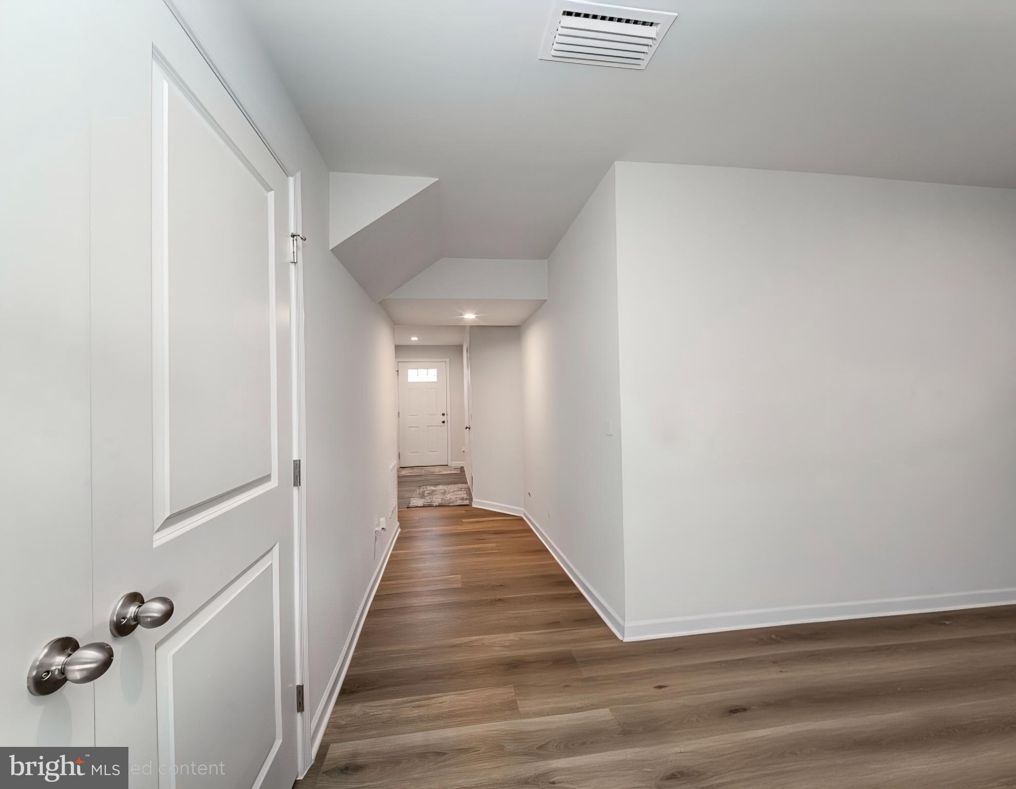 18256 Capital Court Ruther Glen, VA 22546 - Photo 5 of 26 a view of a hallway with wooden floor and staircase
