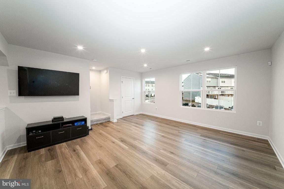 18256 Capital Court Ruther Glen, VA 22546 - Photo 10 of 26 a view of a livingroom with wooden floor and a flat screen tv