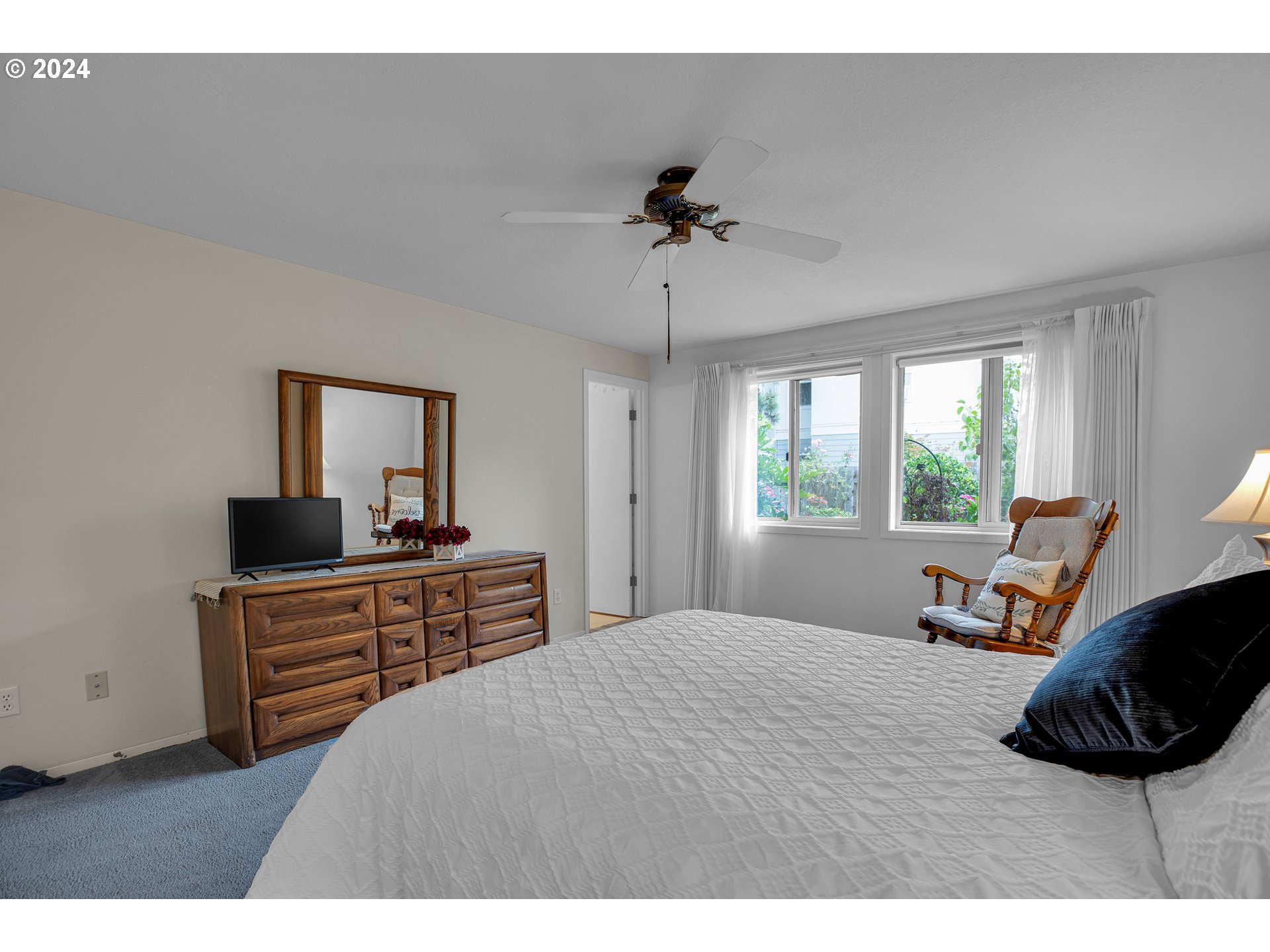 1580 Northwest 175th Place Beaverton, OR 97006 - Photo 16 of 28 a bedroom with a bed and a flat screen tv