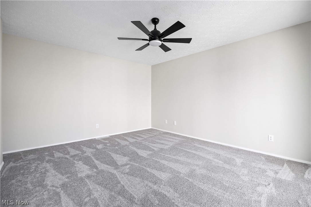32969 Mills Road North Ridgeville, OH 44039 - Photo 16 of 29 Carpeted spare room with a textured ceiling and ceiling fan