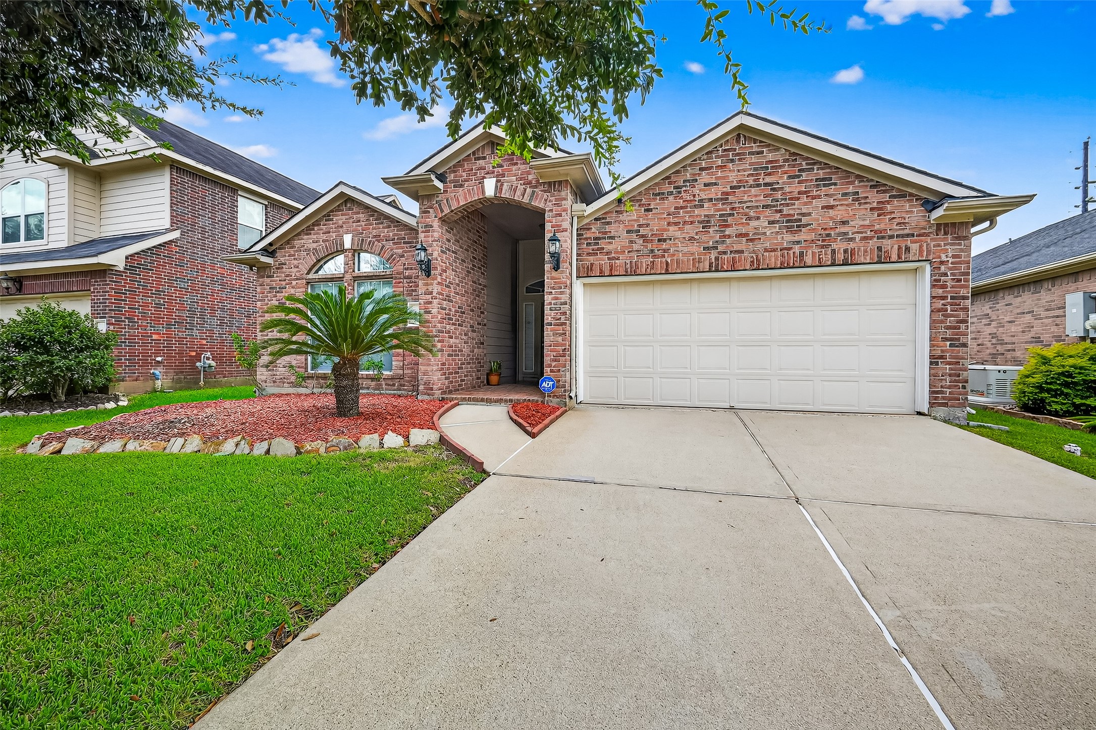 215 Little Summer Drive Rosenberg, TX 77469 - Photo 12 of 16 a front view of a house with a garden and plants