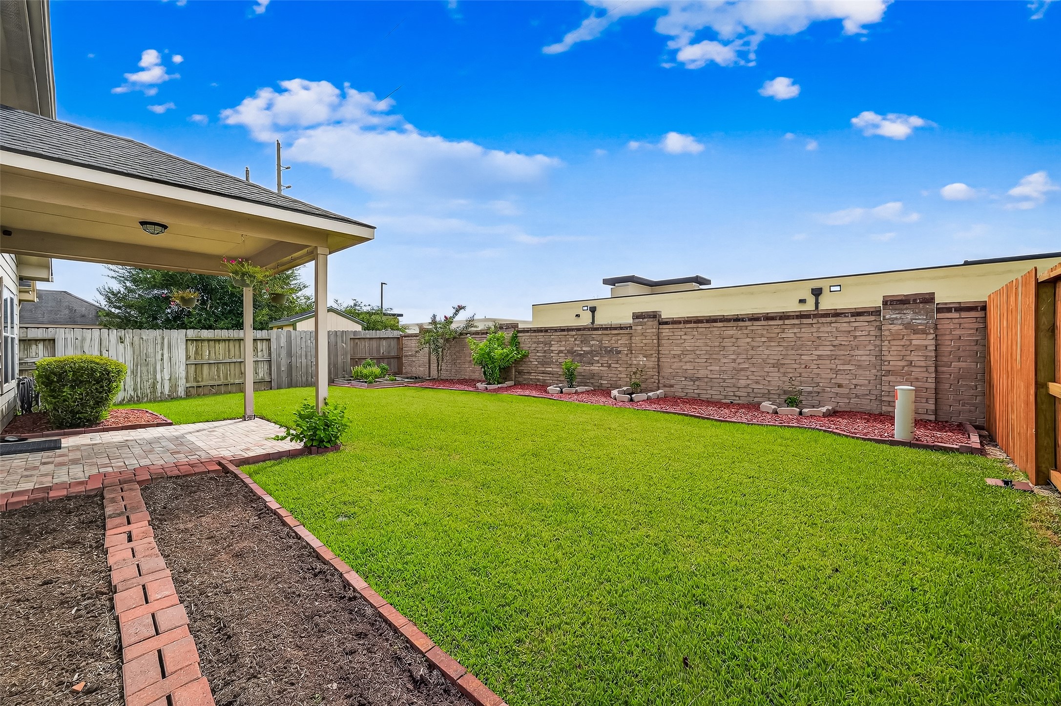 215 Little Summer Drive Rosenberg, TX 77469 - Photo 13 of 16 a view of a backyard with plants and outdoor seating