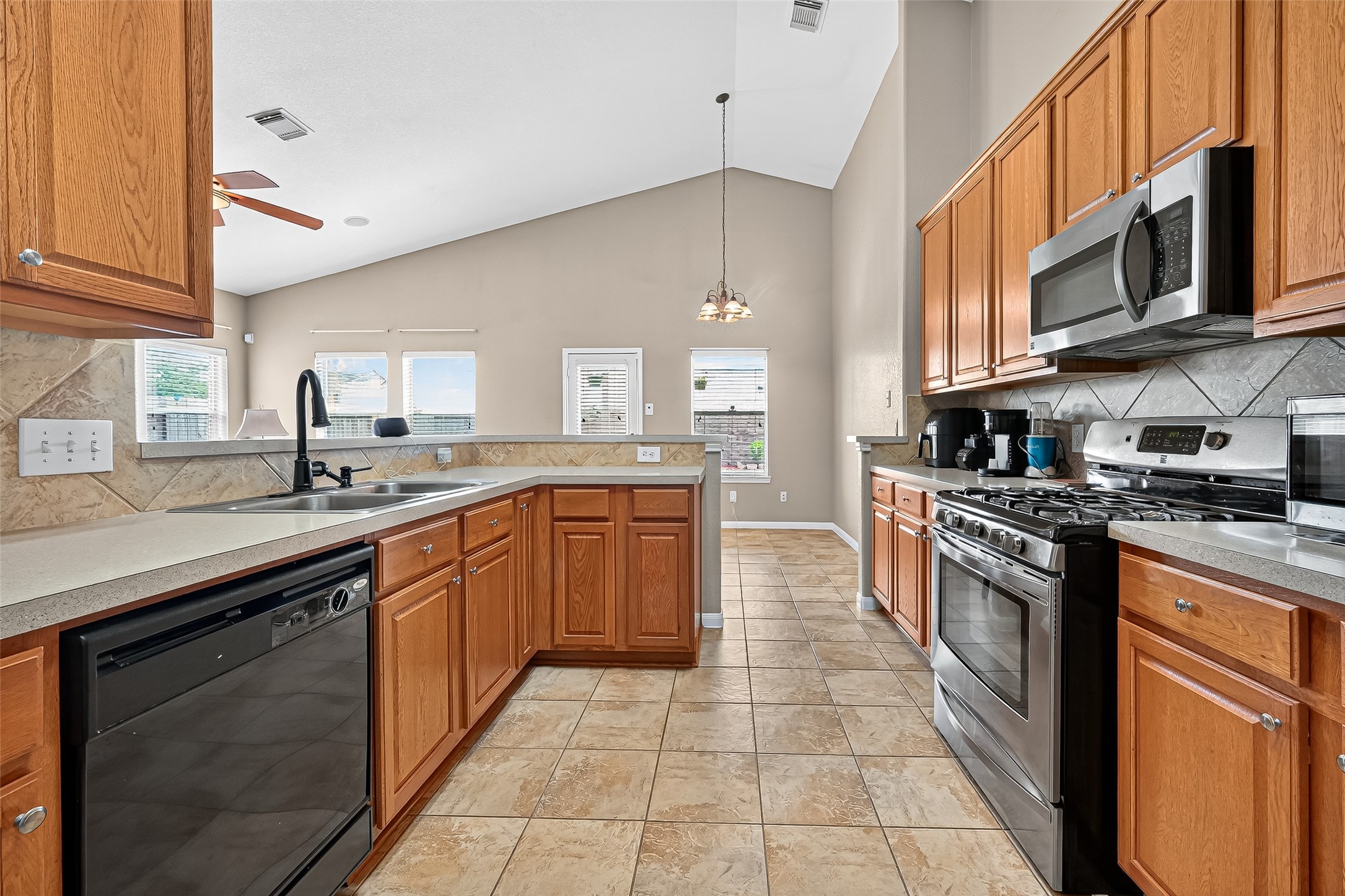 215 Little Summer Drive Rosenberg, TX 77469 - Photo 10 of 16 a kitchen with stainless steel appliances granite countertop a sink and cabinets