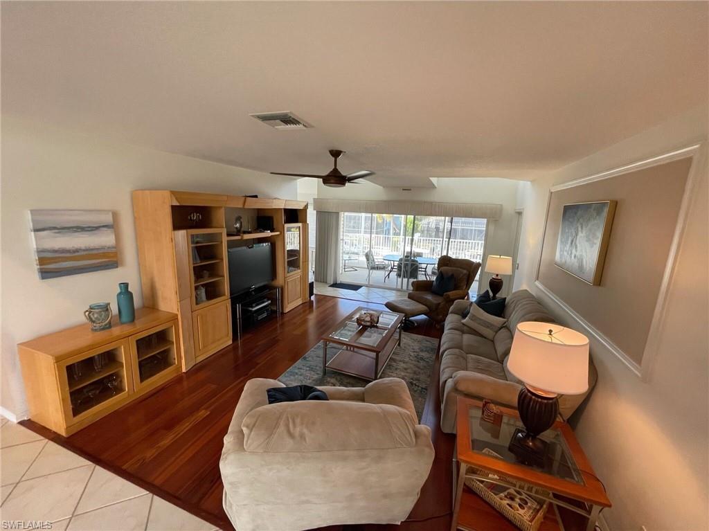 405 Cristobal Street Naples, FL 34113 - Photo 15 of 24 a living room with furniture and a flat screen tv