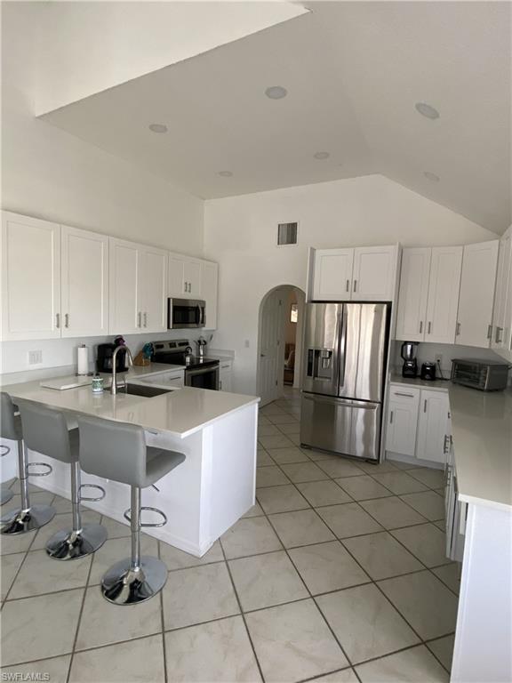 405 Cristobal Street Naples, FL 34113 - Photo 16 of 24 a kitchen with stainless steel appliances a refrigerator sink and cabinets