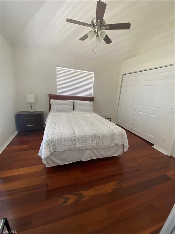 405 Cristobal Street Naples, FL 34113 - Photo 22 of 24 a bedroom with a bed and wooden floor