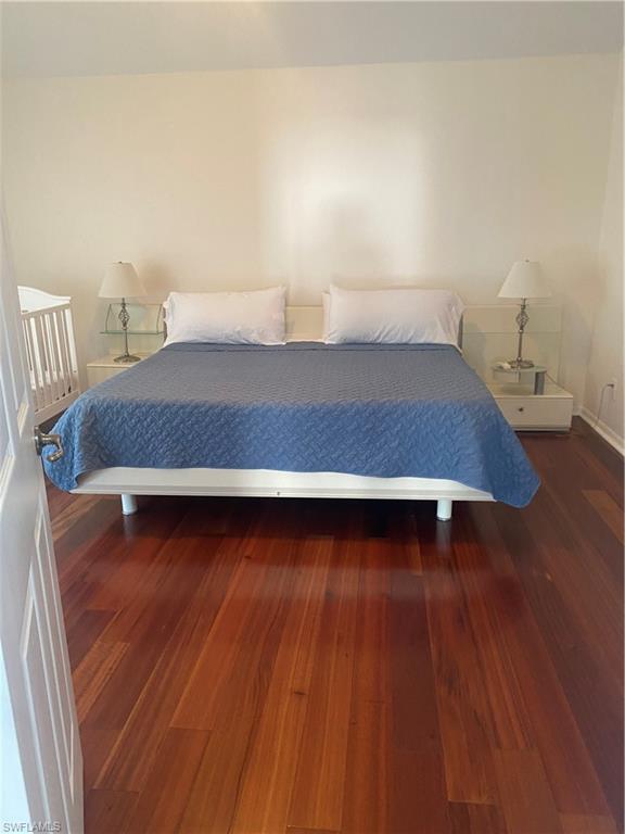 405 Cristobal Street Naples, FL 34113 - Photo 24 of 24 a bedroom with a bed and wooden floor