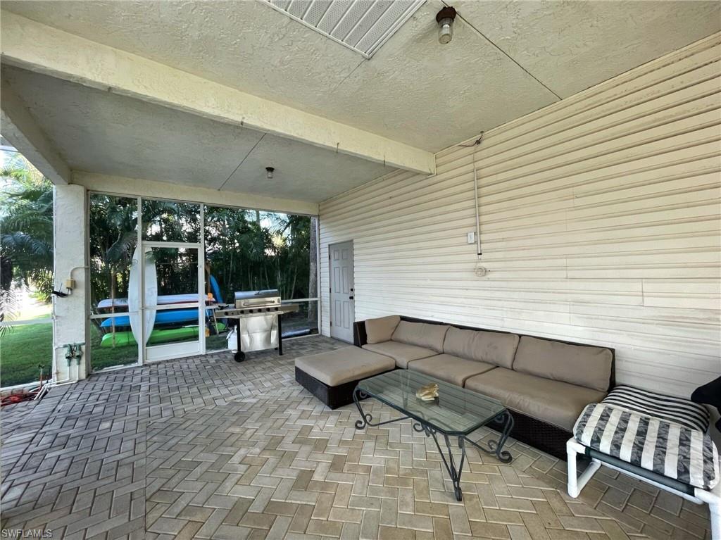 405 Cristobal Street Naples, FL 34113 - Photo 6 of 24 a view of a patio with chairs and a table