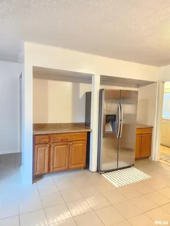 a spacious bathroom with a granite countertop sink and a mirror
